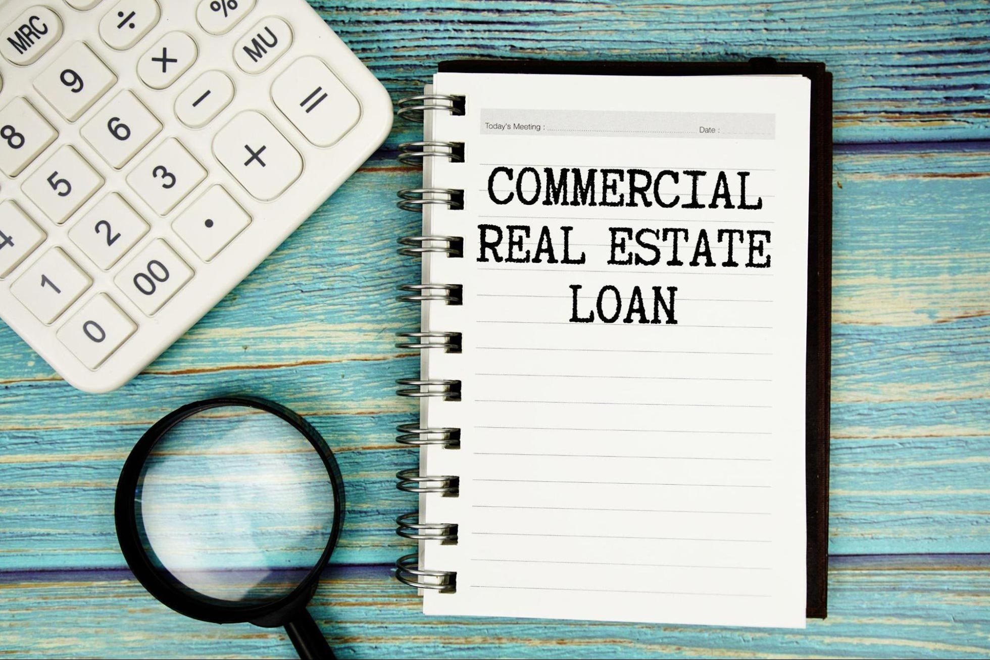 Commercial loan refinancing documents, calculator, and building plans representing ARC Private Lending’s Los Angeles lending solutions